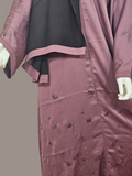 Close-up of beaded floral detail on dusty mauve abaya sleeve