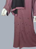Dusty mauve beaded floral abaya with black hijab and front zip, on a mannequin