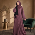 Dusty mauve beaded floral abaya with black hijab, full length, worn by a model