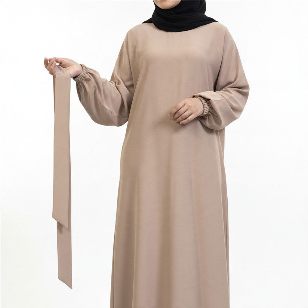BelleNoor beige maxi abaya dress with long balloon sleeves and elasticated cuffs, worn with a black hijab
