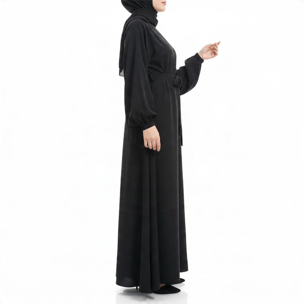 BelleNoor black Nida abaya featuring a tie-waist, long sleeves with cuffs, and an elegant flowing drape