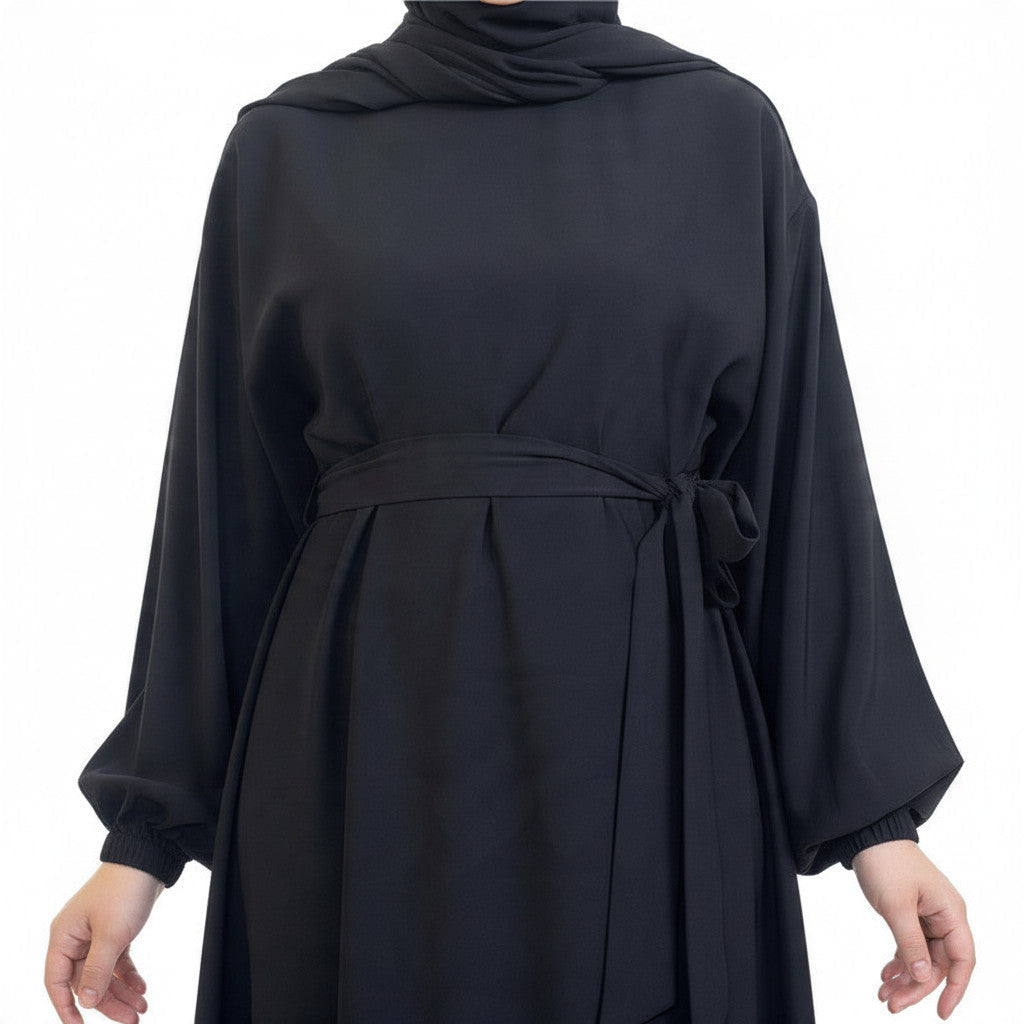 BelleNoor black Nida abaya with a belted waist and elegant draped sleeves, perfect for everyday sophisticated wear.