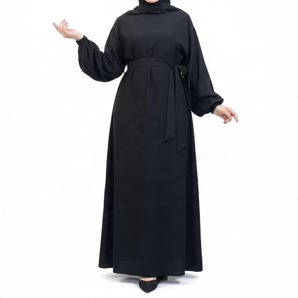 BelleNoor black Nida abaya with long puff sleeves and a matching waist tie, featuring an elegant, flowing drape.