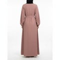 Back view of a BelleNoor dusty rose maxi abaya with long sleeves, elastic cuffs, and a matching waist tie.