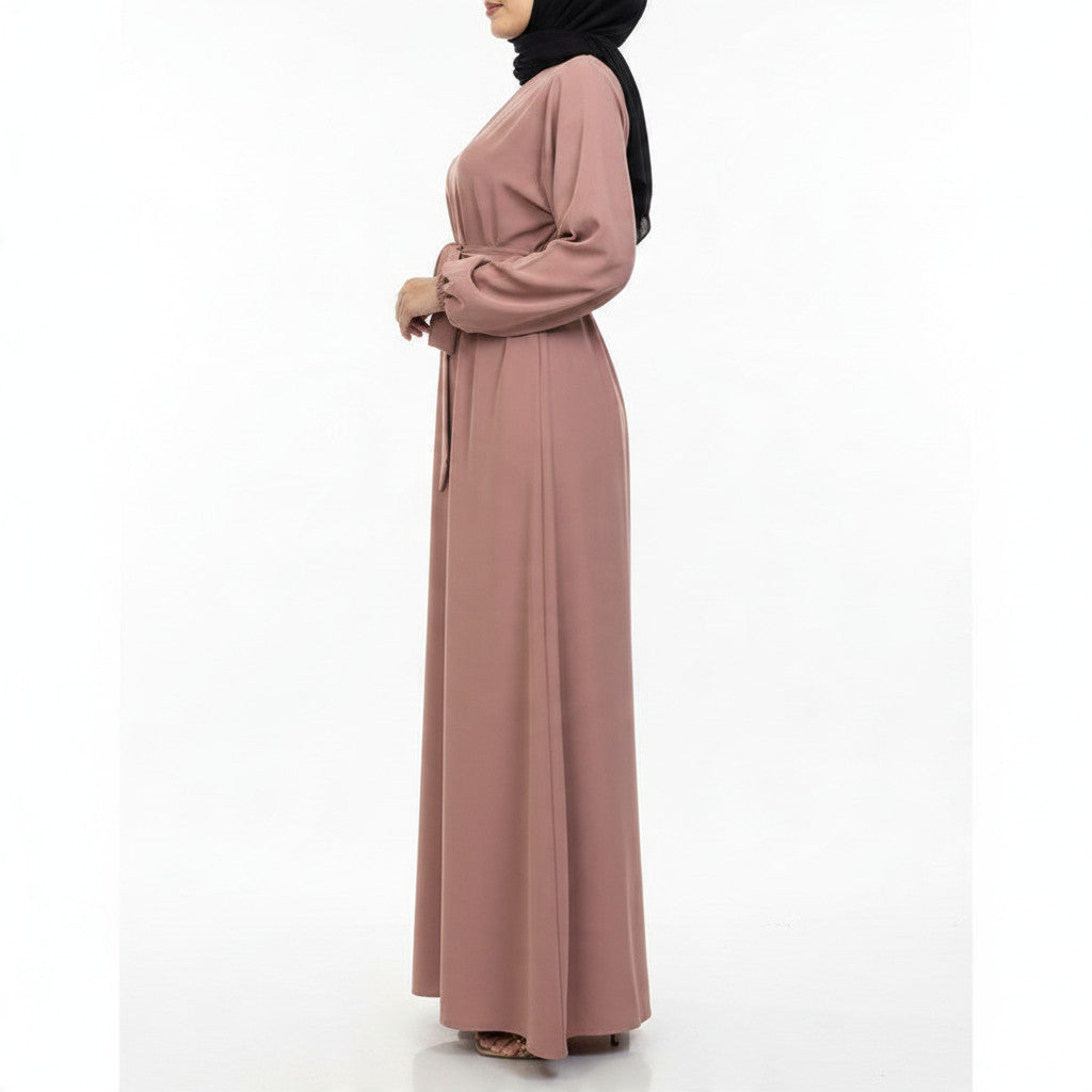 BelleNoor dusty rose Nida abaya with a belted waist, worn by a model in a side profile view.