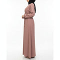 BelleNoor dusty rose Nida abaya with a belted waist, worn by a model in a side profile view.