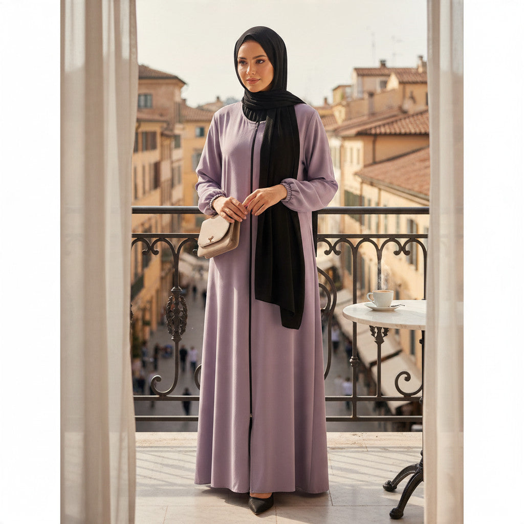 BelleNoor lavender abaya with front zipper and black chiffon hijab worn by a woman on a balcony