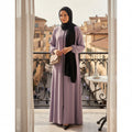BelleNoor lavender abaya with front zipper and black chiffon hijab worn by a woman on a balcony