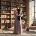BelleNoor lavender abaya with front zipper and black chiffon hijab worn by a woman reading in a library setting