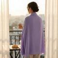 BelleNoor light purple crepe chiffon hijab draped over a woman's shoulders while standing on a balcony at sunset.