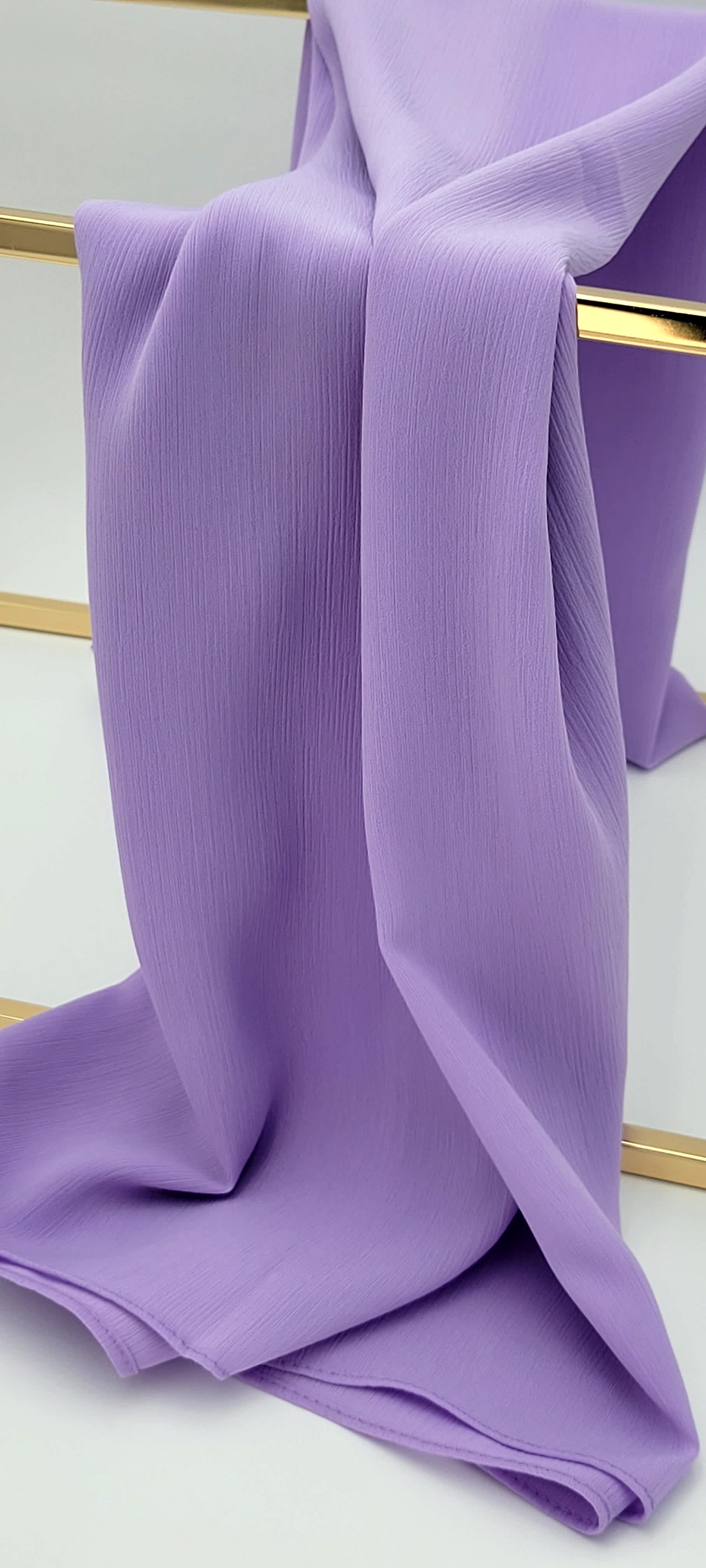 BelleNoor light purple crepe chiffon hijab with a subtle textured finish draped elegantly over a gold stand