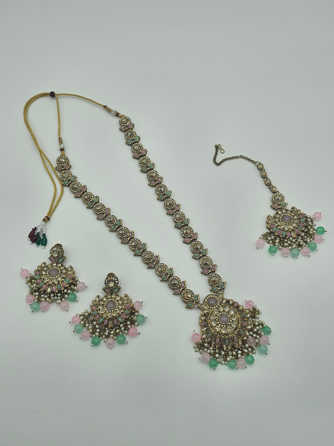 BelleNoor long Kundan necklace set with Meenakari leaf details, pearl clusters, and pink and mint green bead drops.