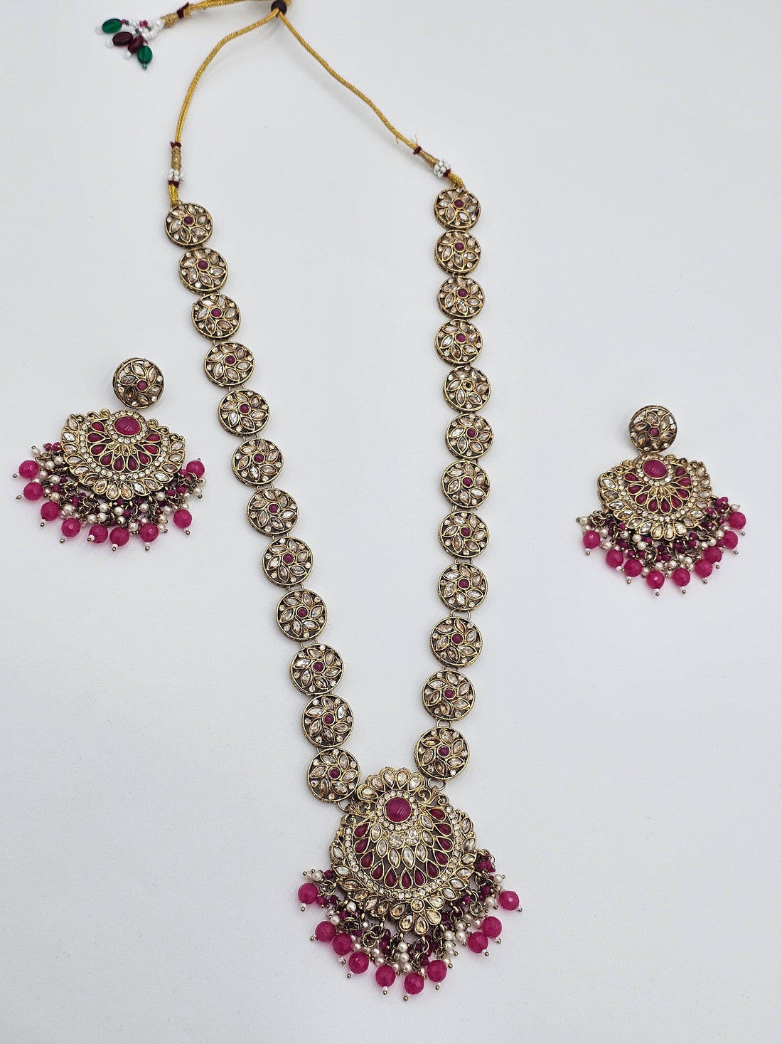 BelleNoor long Kundan necklace set featuring pink Meenakari work, intricate gold-tone metal, and beaded drop accents.
