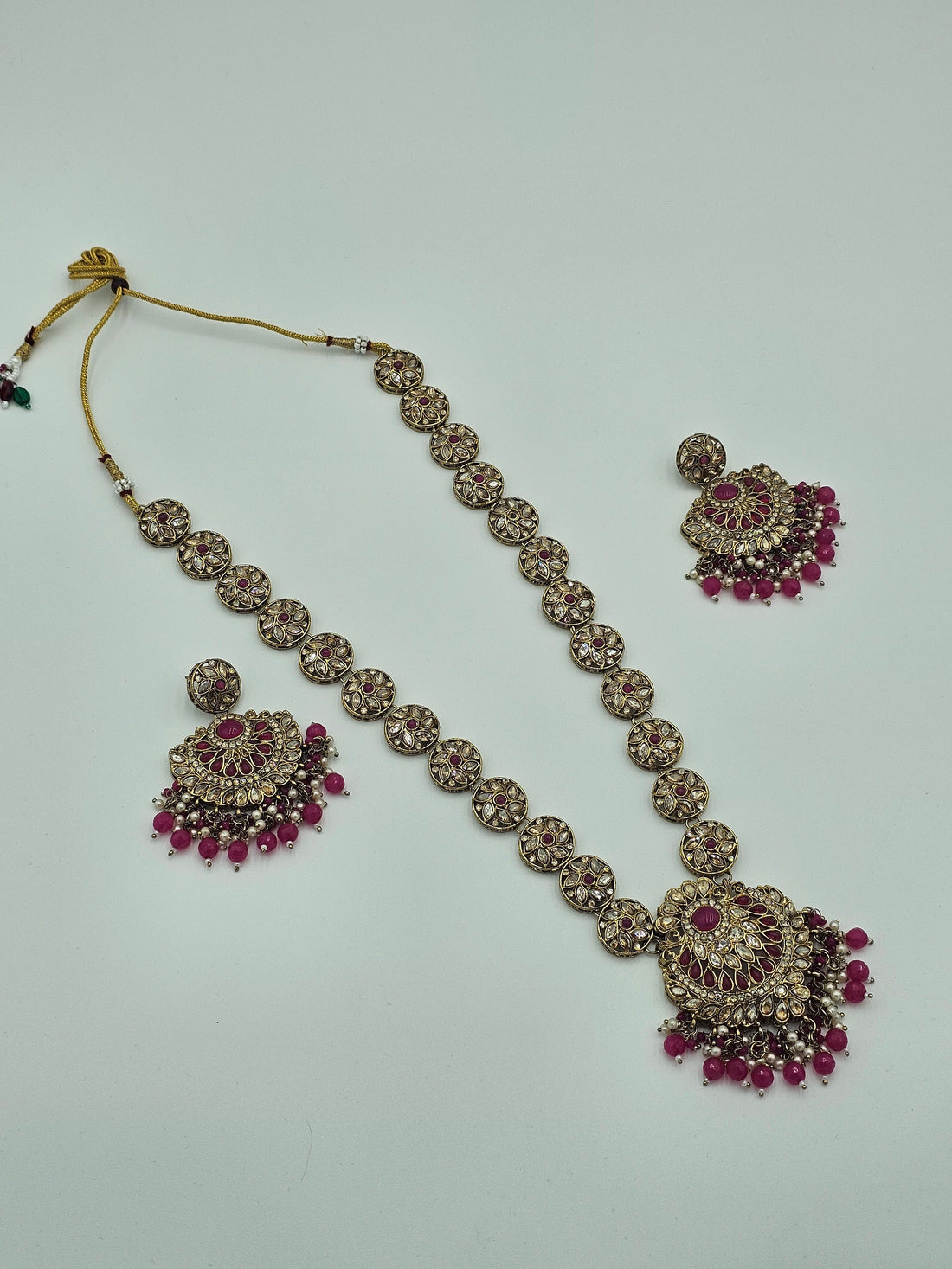 BelleNoor long Kundan necklace set featuring pink Meenakari work, intricate gold-tone metal, and matching earrings.
