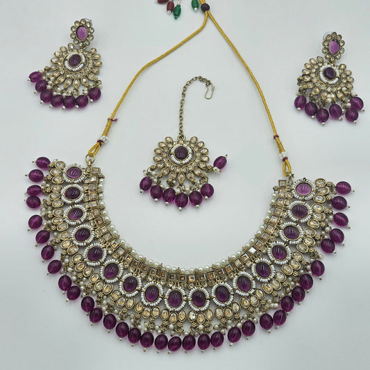 BelleNoor royal purple Kundan jewellery set with statement necklace, chandelier earrings, and matching maang tikka.