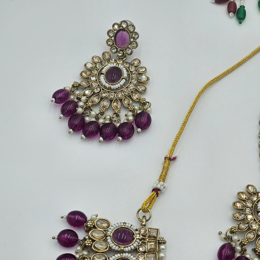 BelleNoor royal purple Kundan jewellery set featuring chandelier earrings and maang tikka with gold and pearl accents