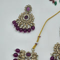 BelleNoor royal purple Kundan jewellery set featuring chandelier earrings and maang tikka with gold and pearl accents