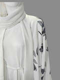 BelleNoor white abaya with black and grey floral branch print, open front, waist tie, and matching hijab on mannequin