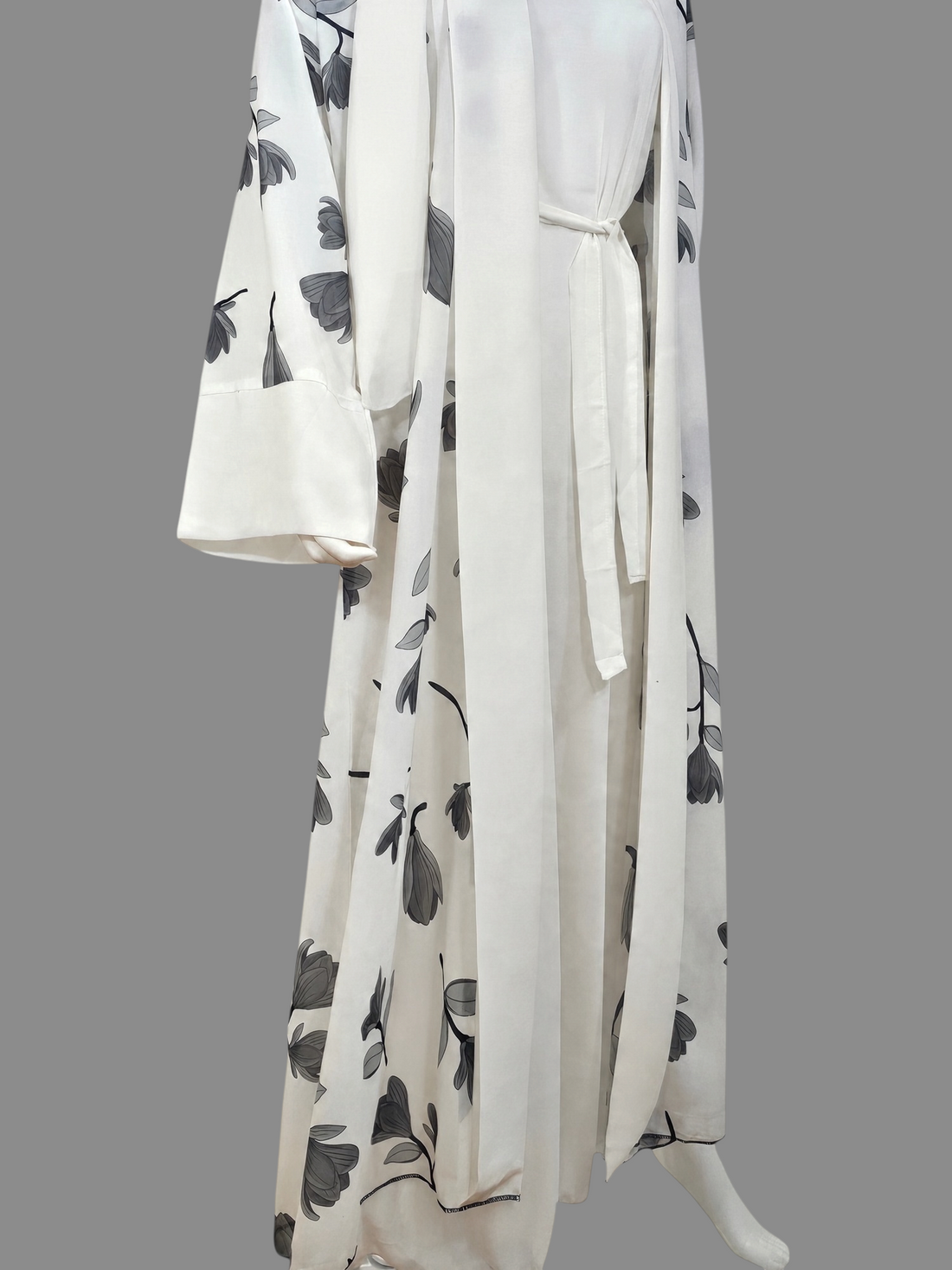 BelleNoor white abaya featuring a black and grey floral branch print, open front, waist tie, and matching hijab.