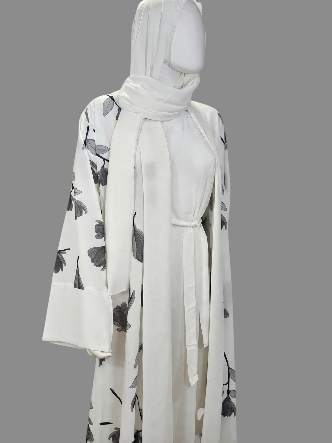 BelleNoor white abaya featuring a black and grey floral branch print, wide sleeves, waist tie, and matching hijab.
