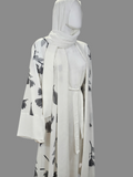BelleNoor white abaya featuring a black and grey floral branch print, wide sleeves, waist tie, and matching hijab.