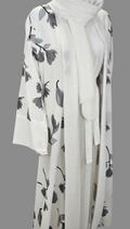BelleNoor white abaya with black and grey floral branch print, wide sleeves, waist tie, and matching hijab.