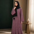 Dusty mauve beaded floral abaya with black hijab worn, full length